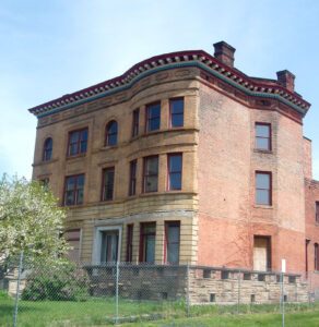 Three storey curved front yellow and red brick home