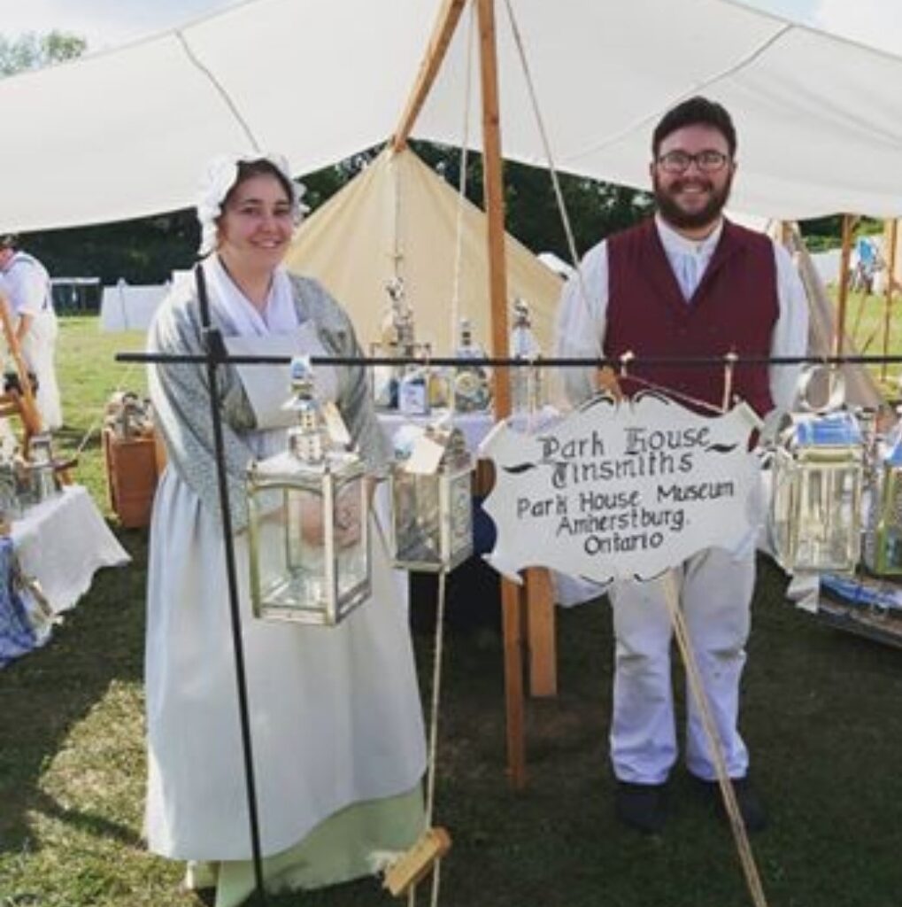 Woman and man man at a tinware sales tent booth